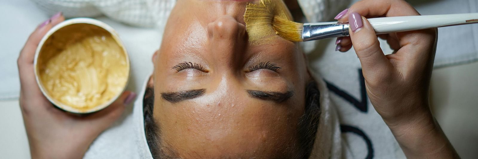 Image of a lady applying face mask.